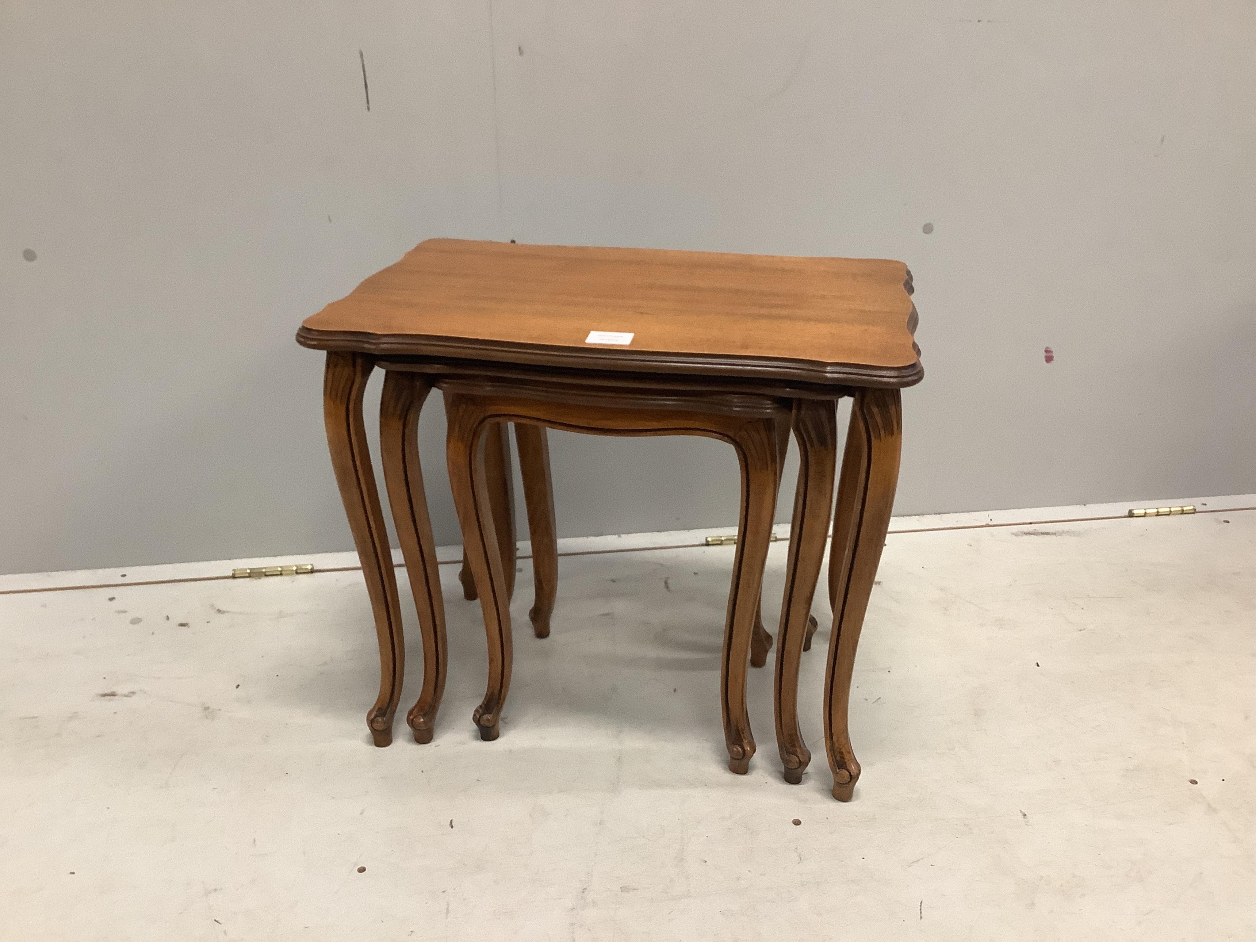 A nest of three mahogany tea tables, on slender cabriole legs, width 58cm, depth 38cm, height 49cm. Condition - good